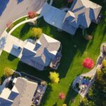 A picturesque aerial view showcasing suburban homes with vibrant gardens and tree-lined streets.